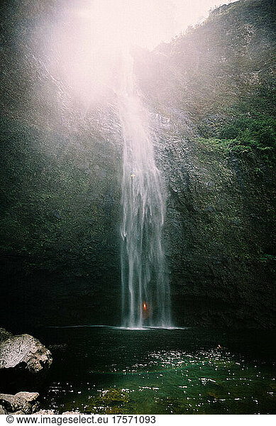 Hanakapi'ai Falls flows Over Massive Rock into a clear pool