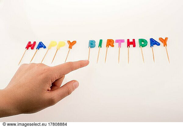 Hand and color candles on sticks write the words happy birthday
