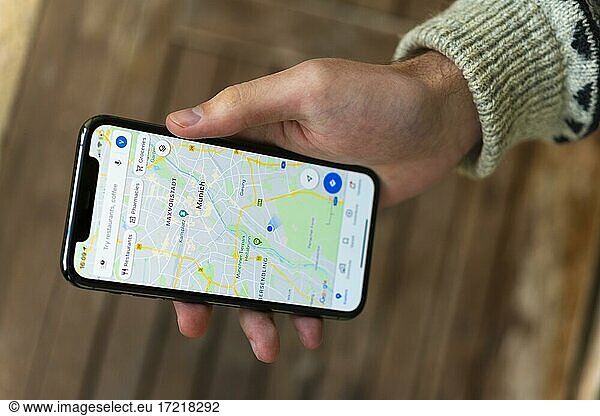 Hand hält iPhone 11 Pro mit Google Maps App  Online Karten Dienst  Bildschirmfoto  Smartphone