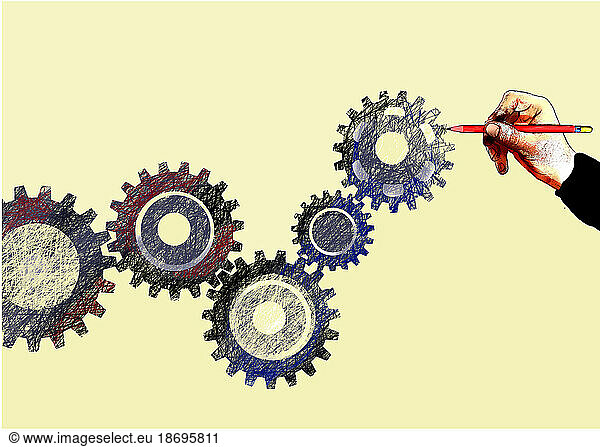 Hand of person drawing interlocked gears