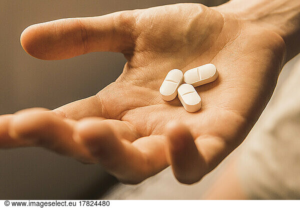 Hand of woman with pills