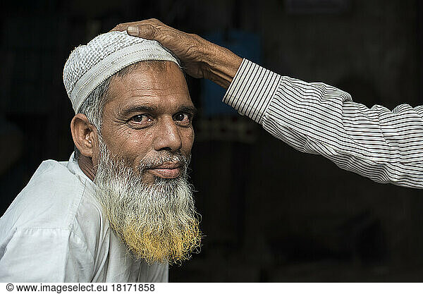 Hand on head of a muslim shopkeeper in Jaipur  India; Jaipur  Rajasthan  India