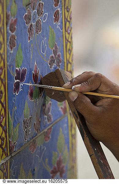 Hand painting ceramic tile at The Grand Palace  Bangkok  Thailand