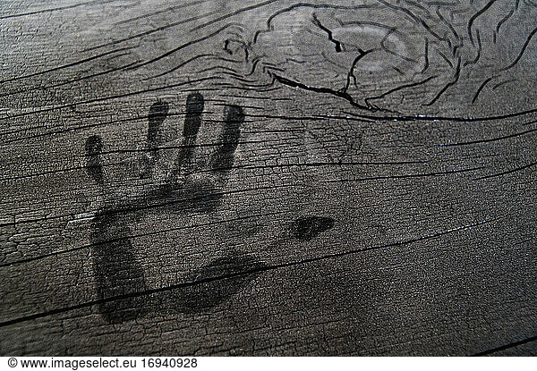 Hand print on wooden surface.