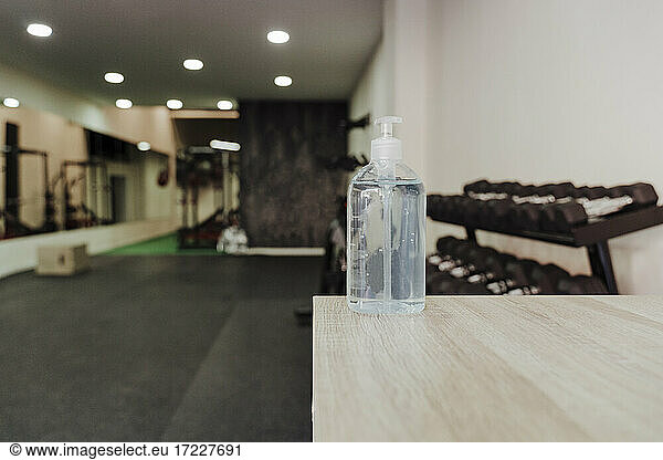 Hand sanitizer bottle on table at gym