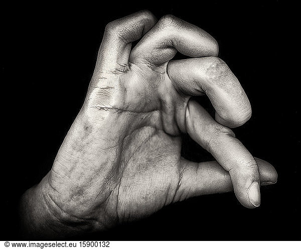 Hand with Contorted Fingers against Black Background