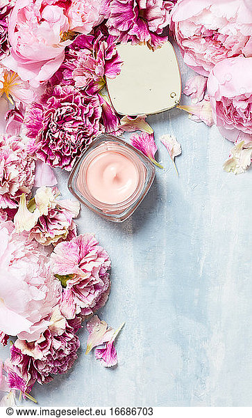 Handcream with roses on textured surface