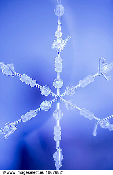 Handmade Snowflake Christmas Ornament on Blue Background