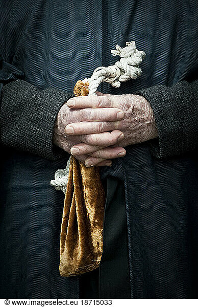 Hands of an elderly male parishioner before the annual Good Friday Pageant at St. Francis Assisi in Toronto  Ontario  Canada.