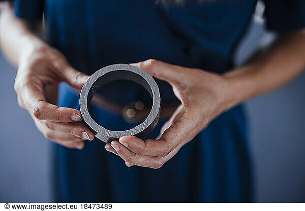 Hands of businesswoman holding circular equipment in office