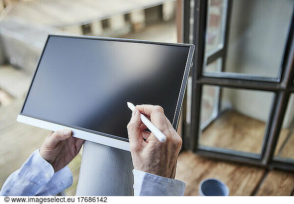 Hands of businesswoman with tablet PC and digitized pen