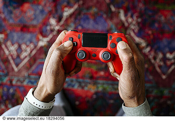 Hands of man holding gamepad