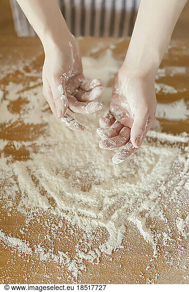 Hands of woman covered in flour