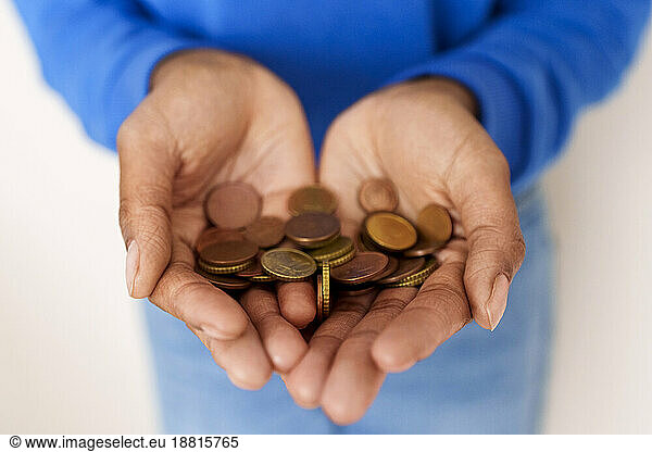 Hands of woman holding coins