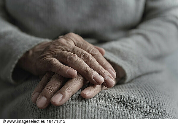Hands of woman on her lap