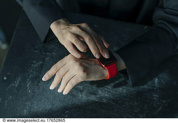 Hands of woman using smart watch