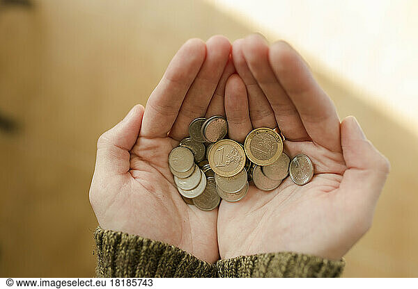 Hands of young man holding coins
