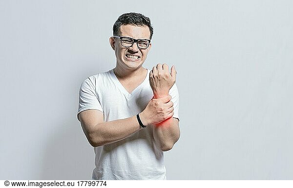 Handsome man with wrist pain isolated  Arthritis and wrist pain concept  People with wrist pain on isolated background  Arthritis man rubbing  Person with wrist pain