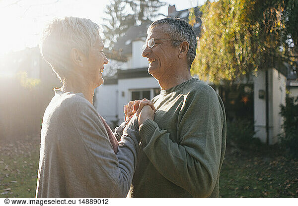 Happy affectionate senior couple in garden