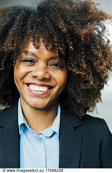 Happy Afro businesswoman wearing suit