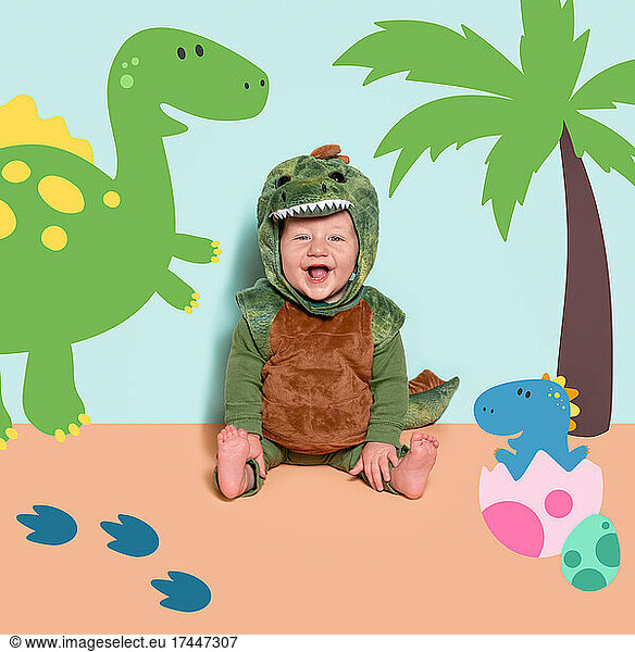 Happy Baby Boy in Dinosaur Halloween Costume Laughing