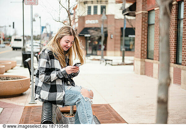 Happy blond teen on her cell phone.