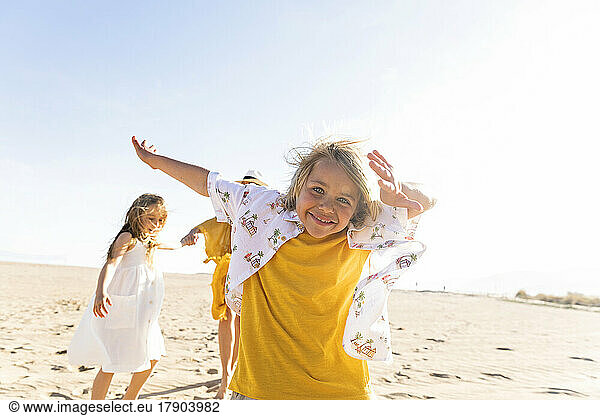 Happy boy enjoying at beach with family on sunny day
