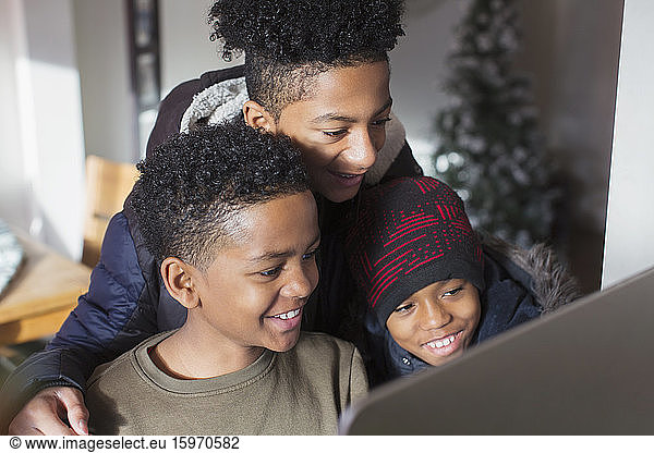 Happy brothers using computer