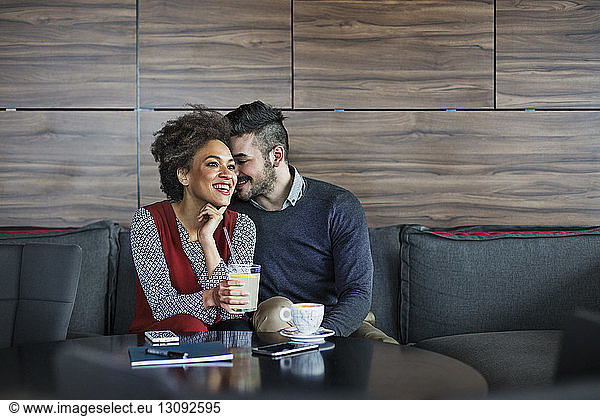 Happy business couple having drinks in restaurant