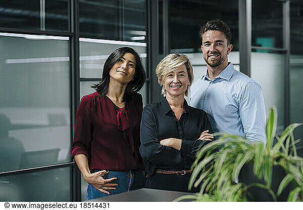 Happy business people standing together in office