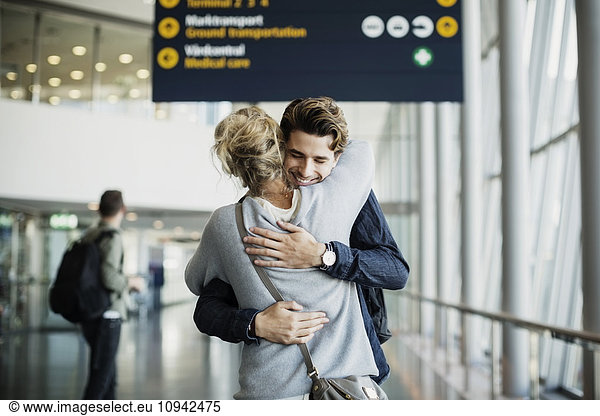 Happy businessman embracing colleague at airport
