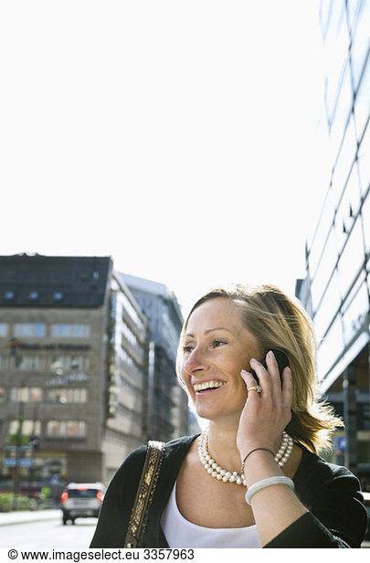 Happy businesswoman talking in cellphone