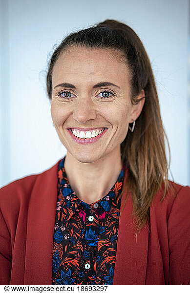Happy businesswoman wearing patterned shirt and blazer