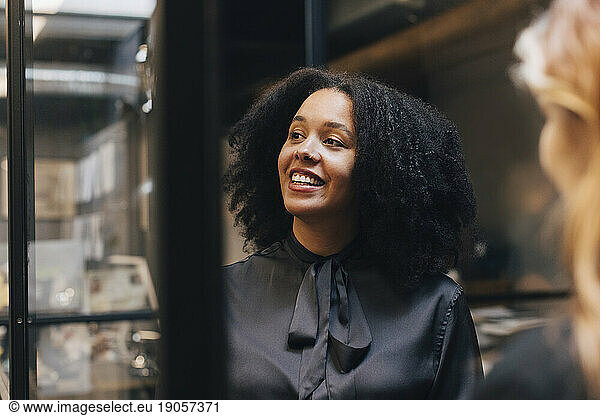 Happy businesswoman with Afro hairstyle in office