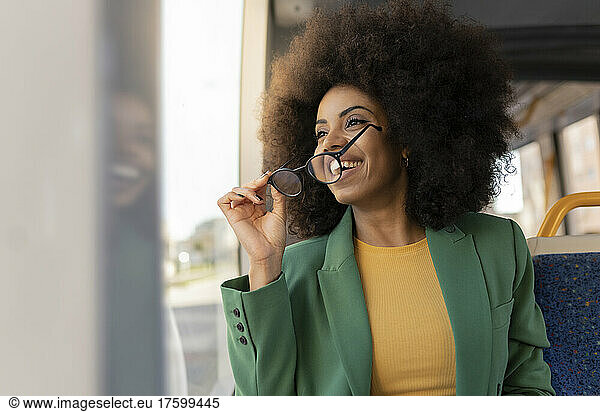 Happy businesswoman with eyeglasses in tram