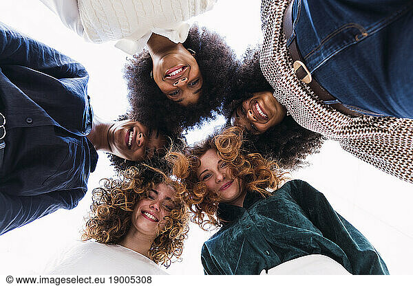 Happy businesswomen huddling together in unity