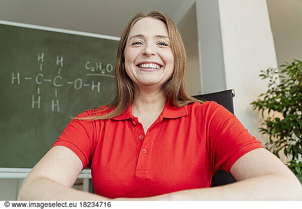 Happy chemistry teacher wearing red polo shirt