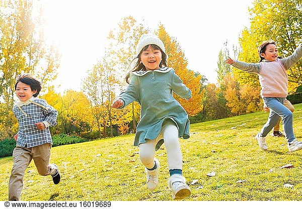 Happy children run on the grass