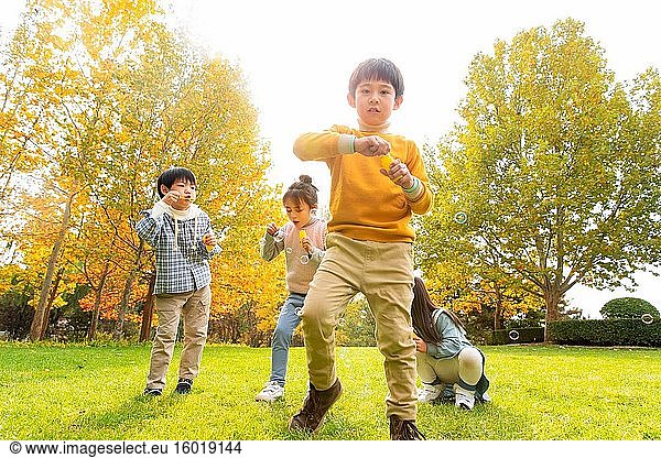 Happy children run to play in the park