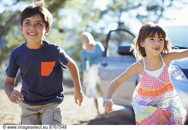 Happy children running from car
