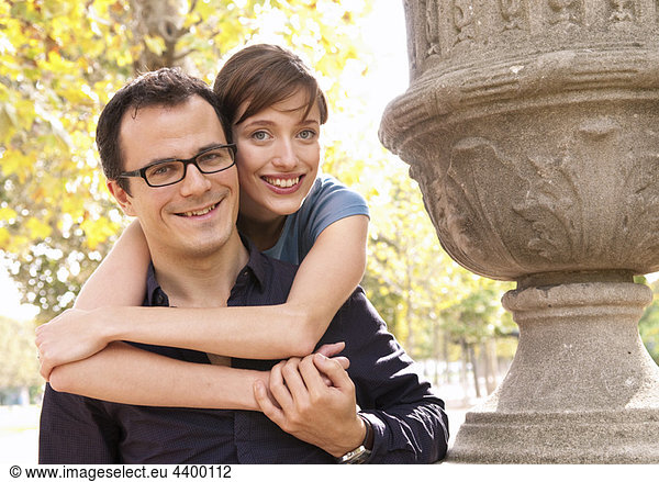 Happy couple embrace in paris park