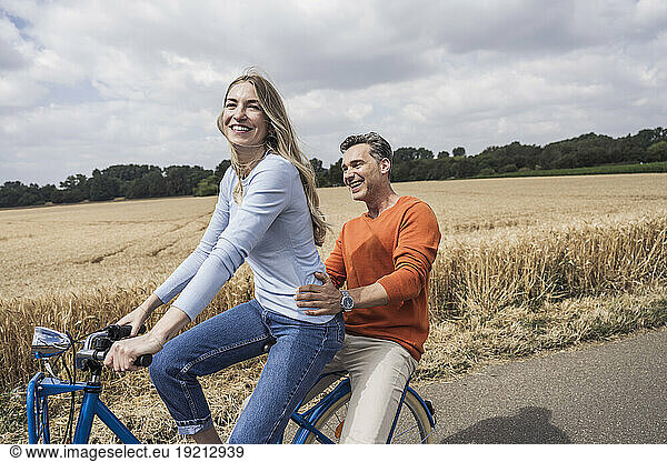 Happy couple enjoying bicycle ride together