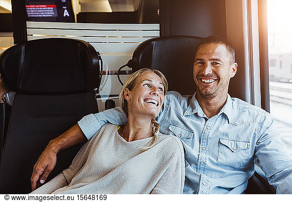 Happy couple enjoying journey in train