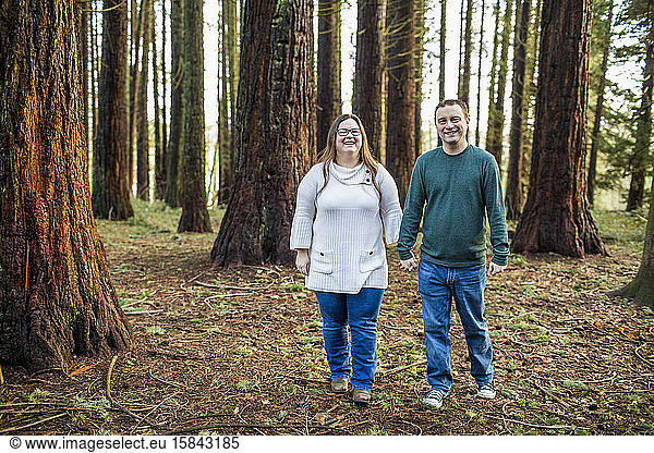 Happy couple enjoying walk through a forested park