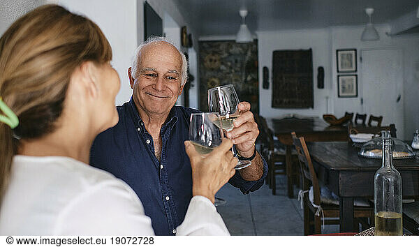 Happy couple enjoying wine in cafe