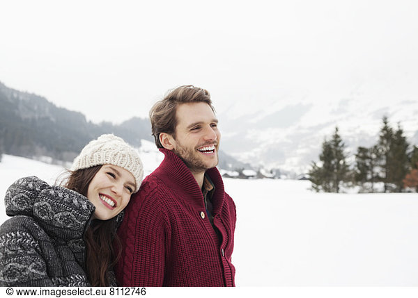 Happy couple in snowy field
