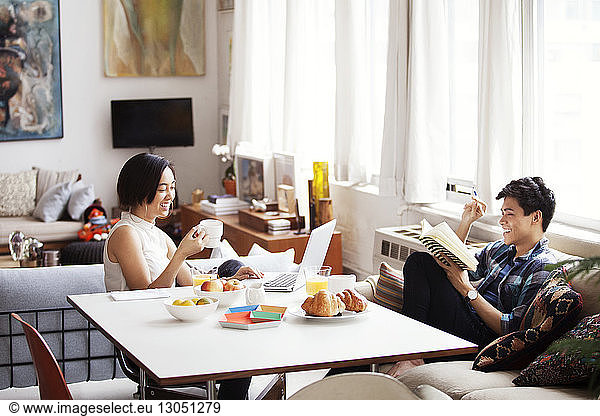 Happy couple spending leisure time in living room