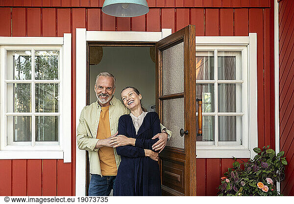 Happy couple spending leisure time near doorway