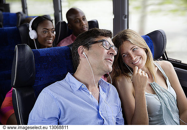 Happy couples sitting in bus
