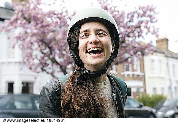 Happy delivery person wearing cycling helmet
